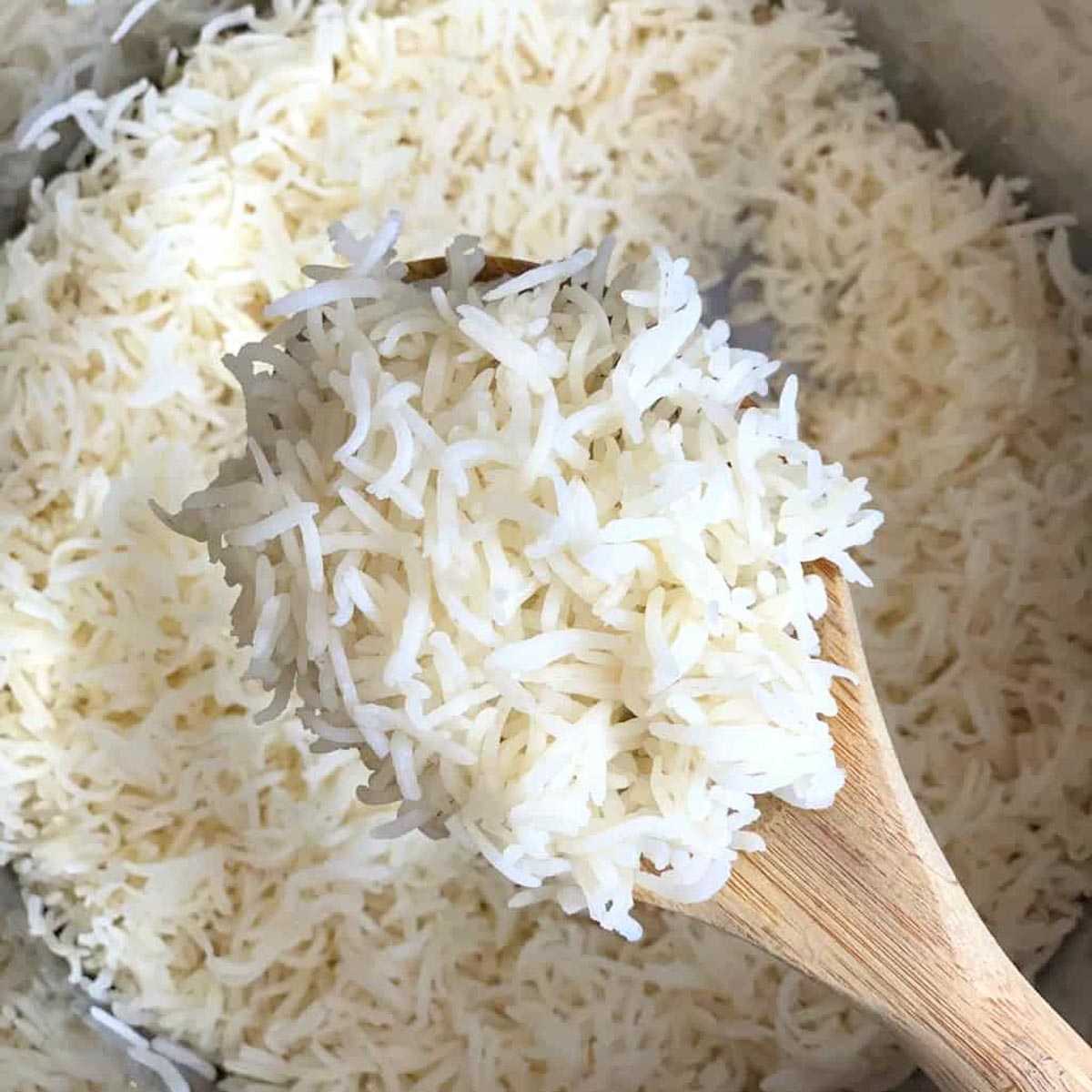 fluffy cooked long grain in a ladle