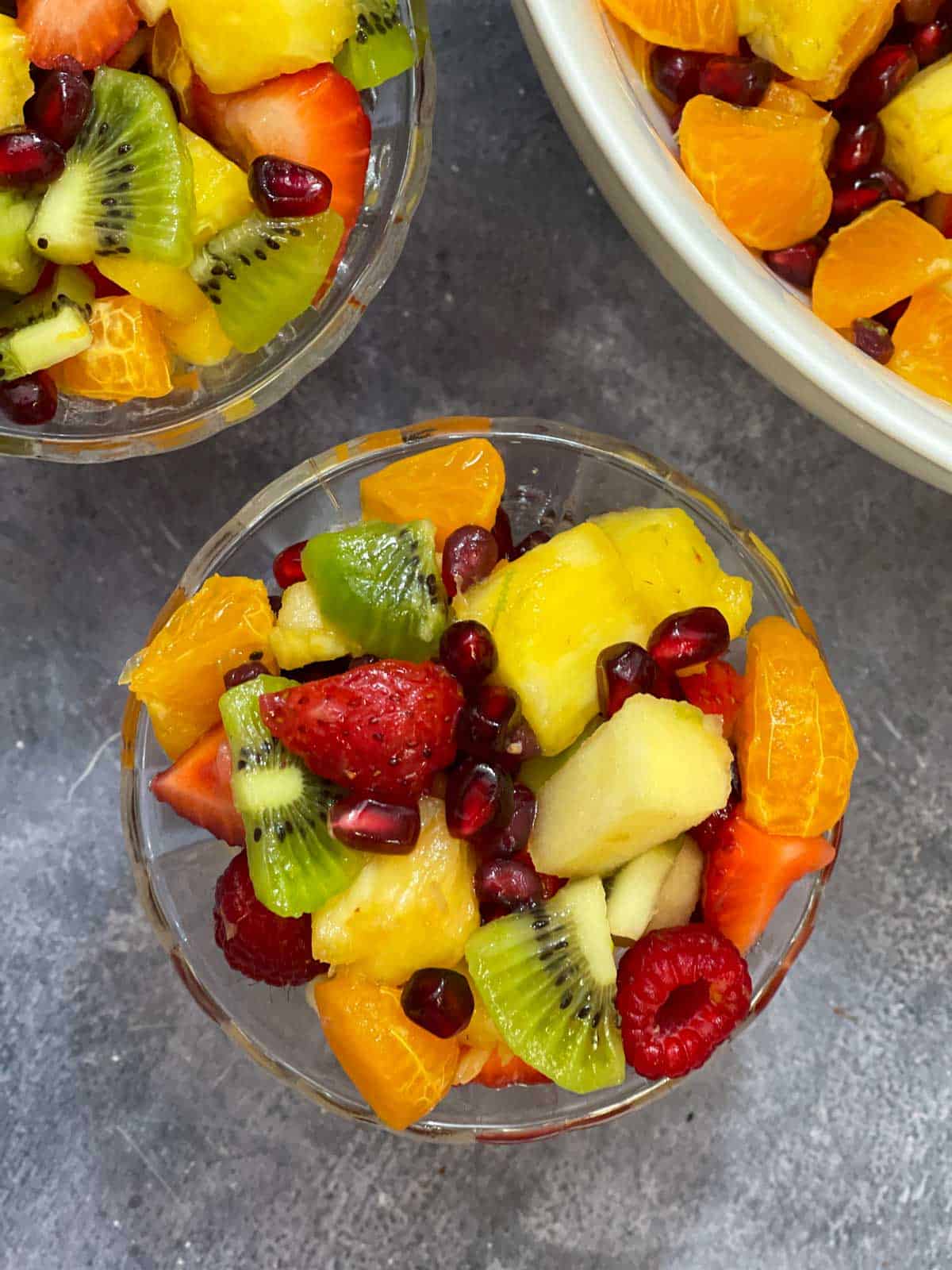 fruit salad with honey lime dressing served in a glass bowl