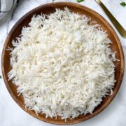 cooked white basmati rice on a plate with spoon on the side