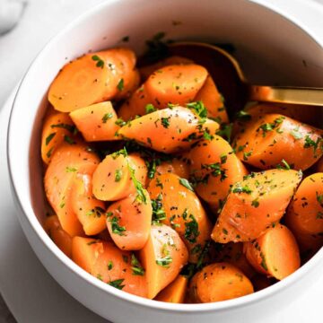 Instant Pot Carrots served in a bowl with a spoon.