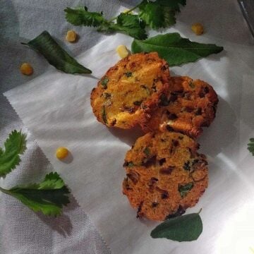 Three air fryer chana dal vada on parchment paper