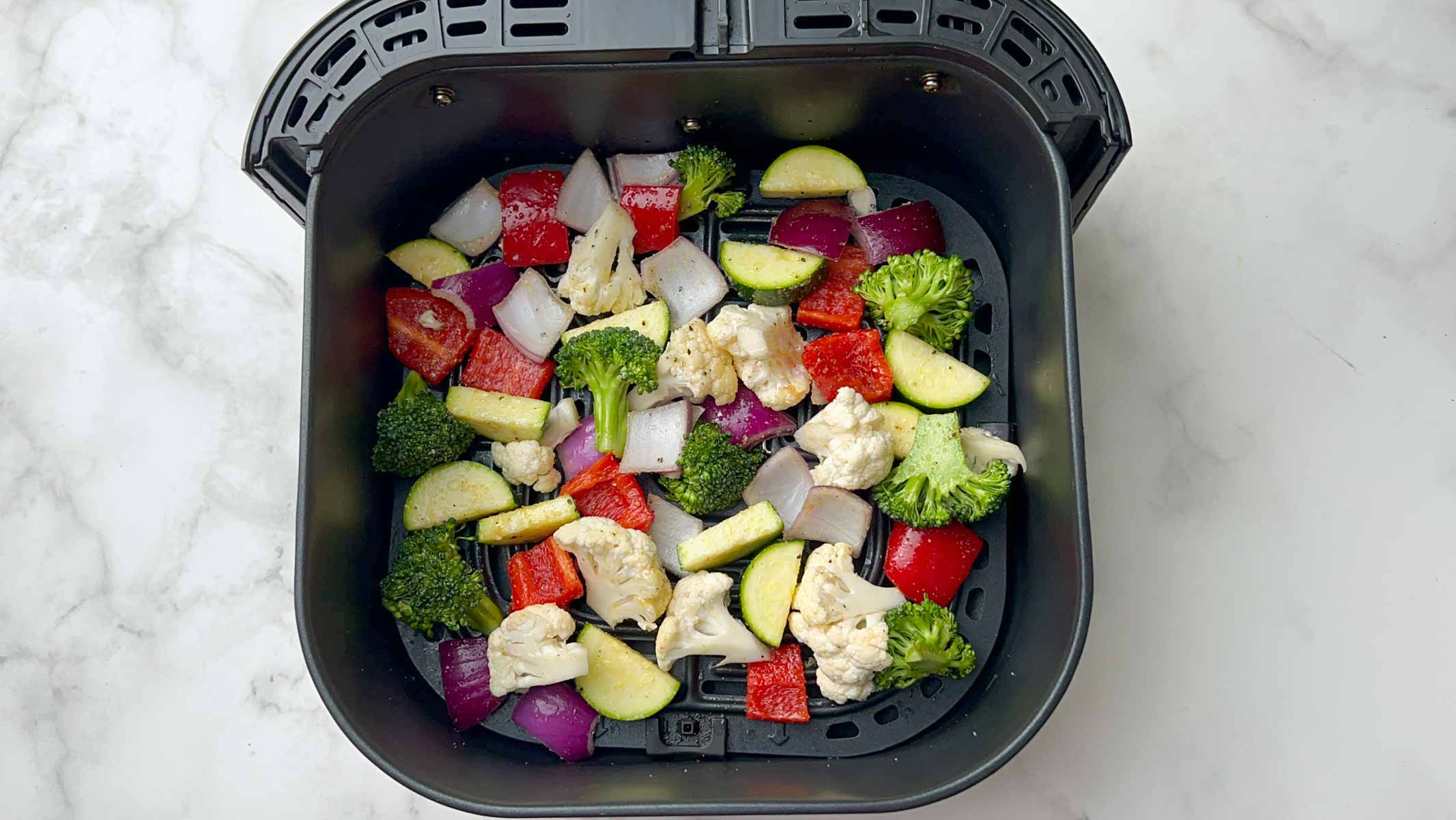 step to add seasoned mixed vegetable in the air fryer basket