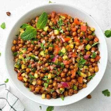 kala chana salad (black chickpeas salad) served in a bowl garnished with mint