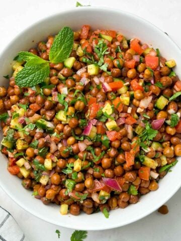 kala chana salad (black chickpeas salad) served in a bowl garnished with mint