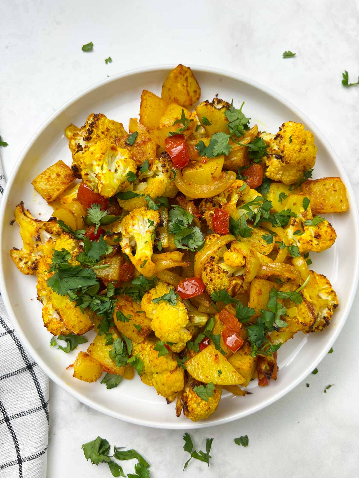 air fryer aloo gobi served on a plate garnished with cilantro