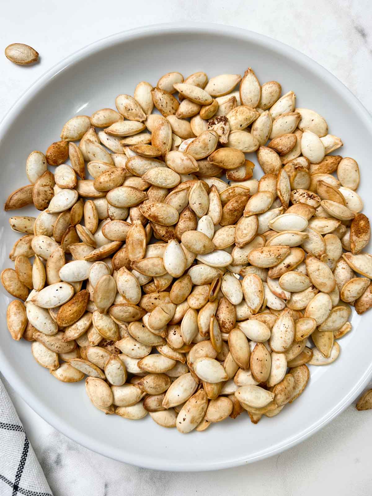 roasted pumpkin seeds served on a plate