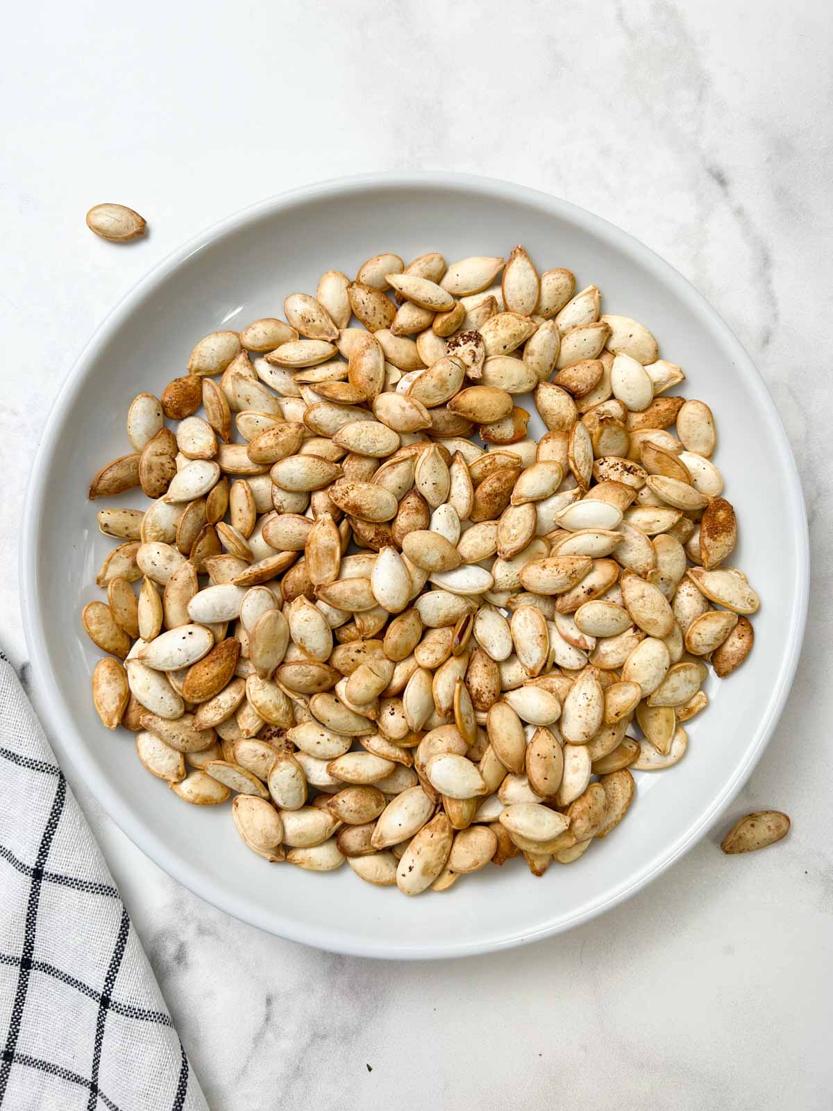 roasted pumpkin seeds served on a plate