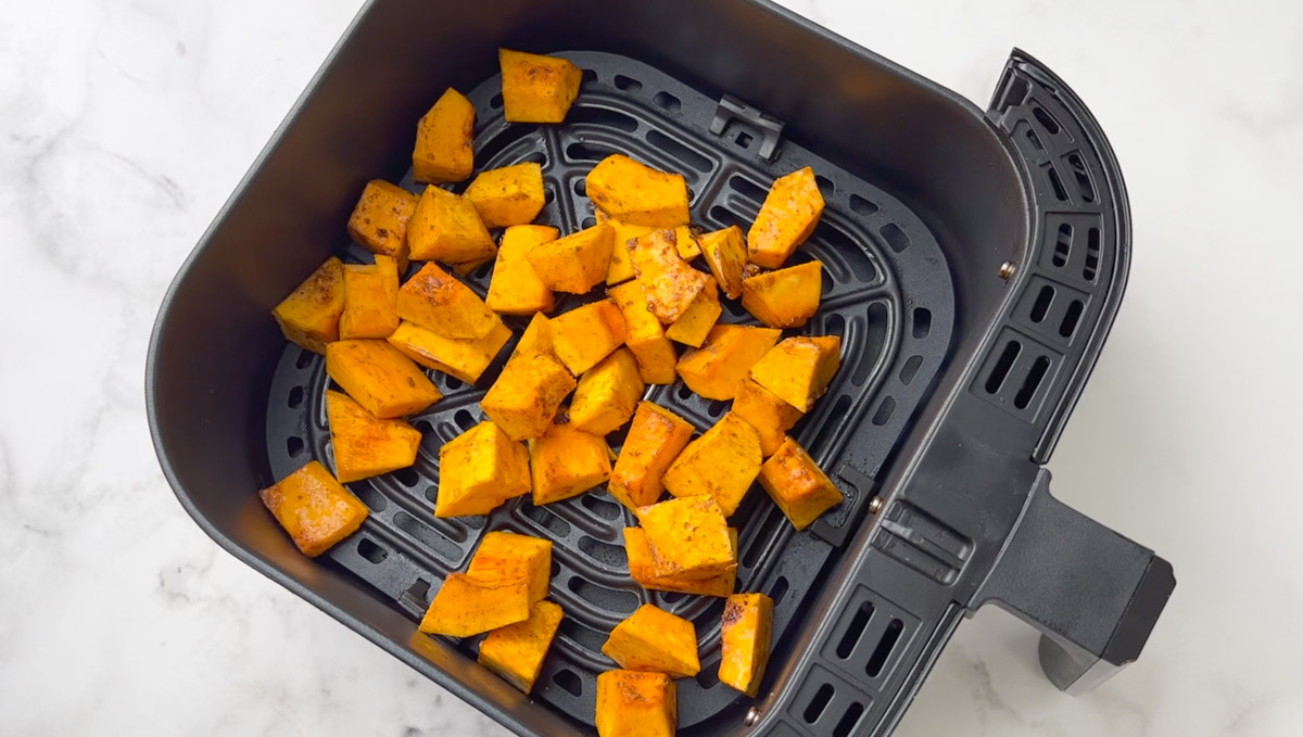 step to add seasoned pumpkin to the air fryer basket