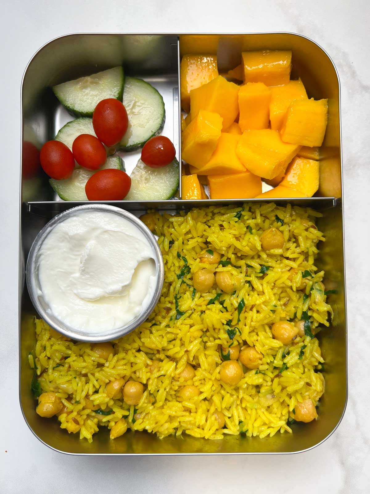 chickpea rice with greek yogurt, mango and salad in bento steel box