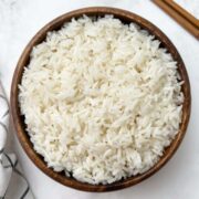 instant pot coconut rice served in a wooden bowl with chopsticks on the side