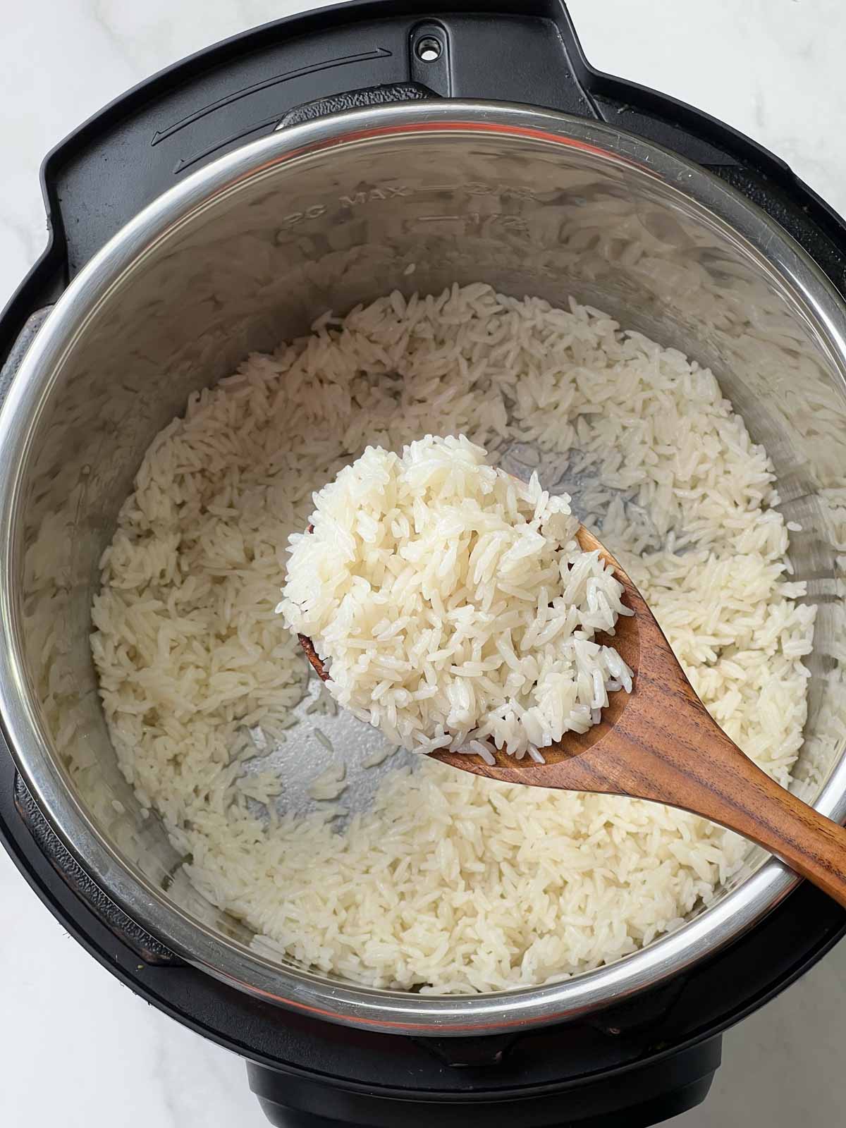 coconut milk in a wooden laddle