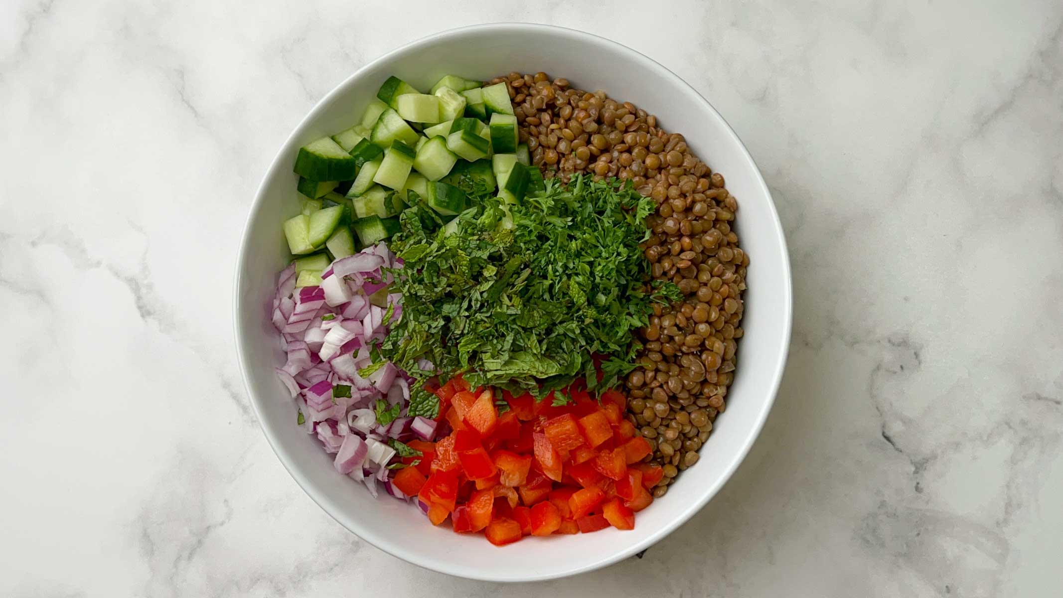 step to add all salad ingredients to a bowl