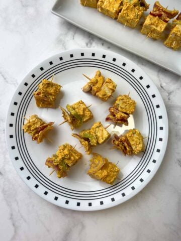 step to thread the marinated tofu tikka into toothpicks