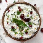 curd rice (thayir saddam) served in a wooden bowl with the tempering on the top