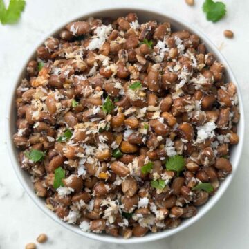 red chori sundal (beans sundal) served in a white bowl garnished with cilantro