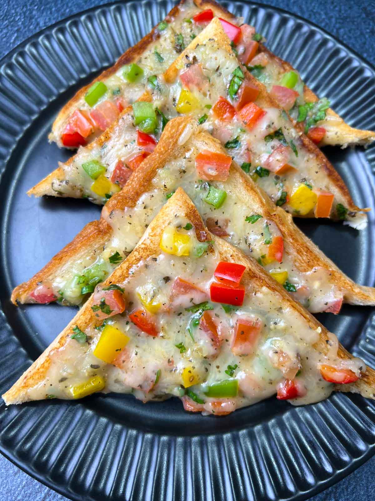 cheese bread toast layered on a plate