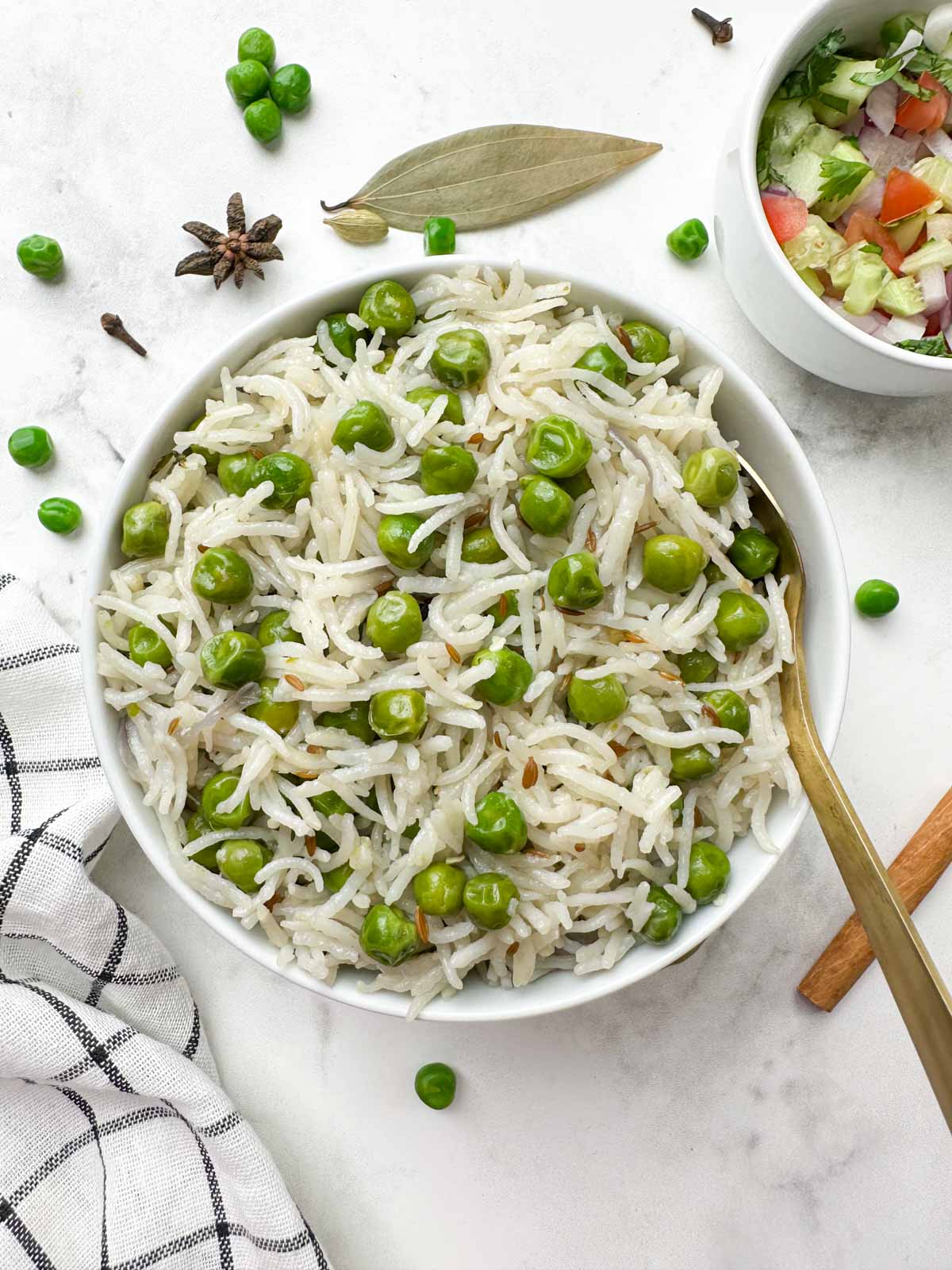 instant pot green peas pulao served in a bowl with salad and spices on the side