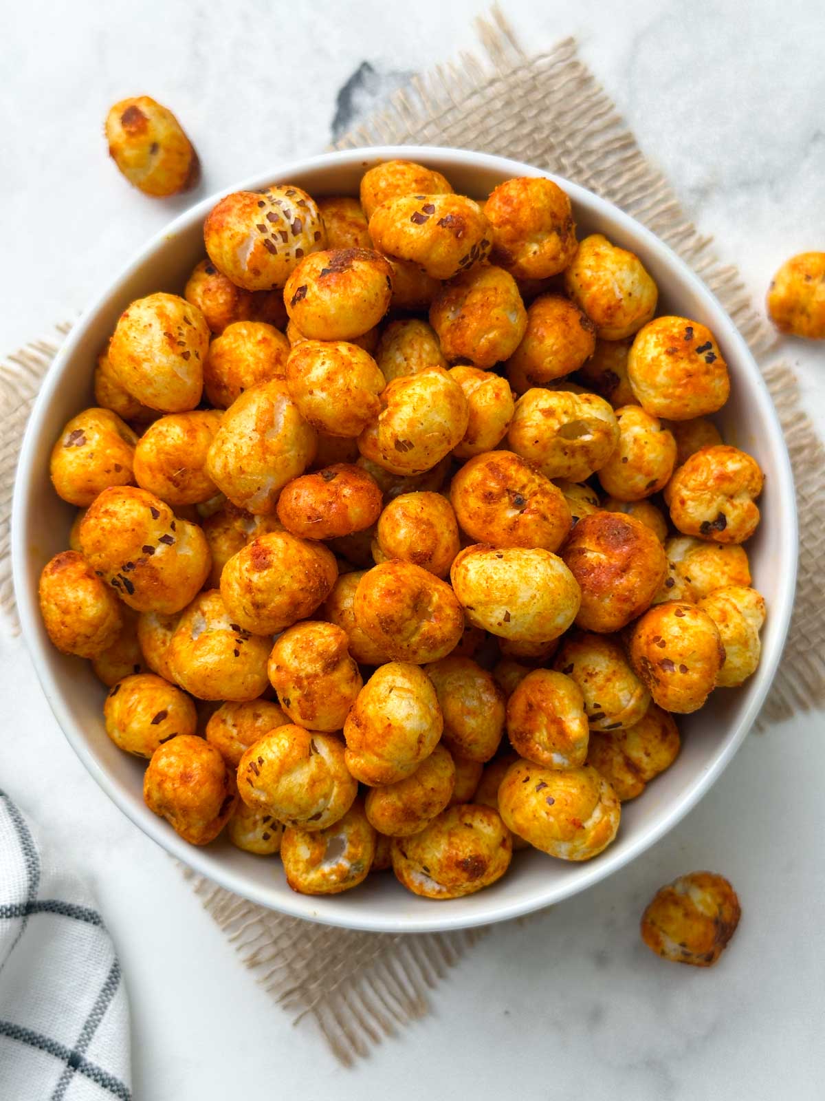 spicy roasted phool makhana in a white bowl