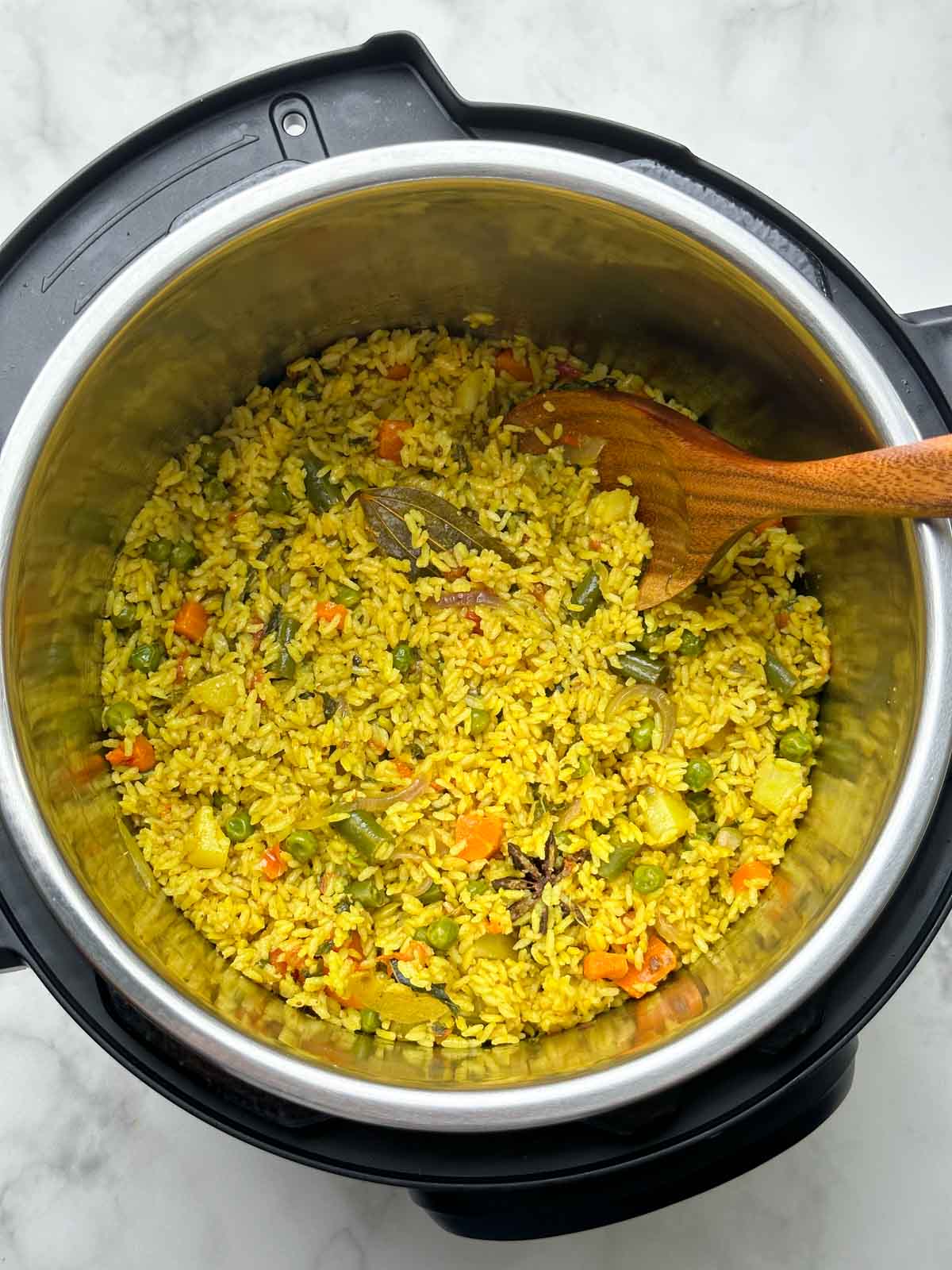 tamil nadu style seeraga samba rice veg biryani in the instant pot with a wooden laddle