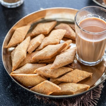 Namak Para served on the plate with tea on the side