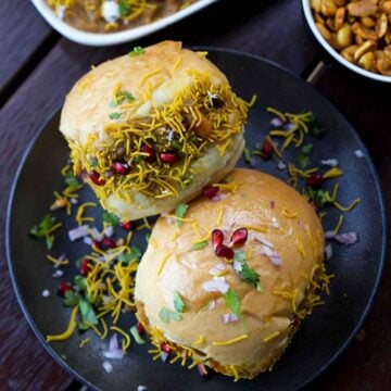 dabeli served on a plate with masala peanuts on the side