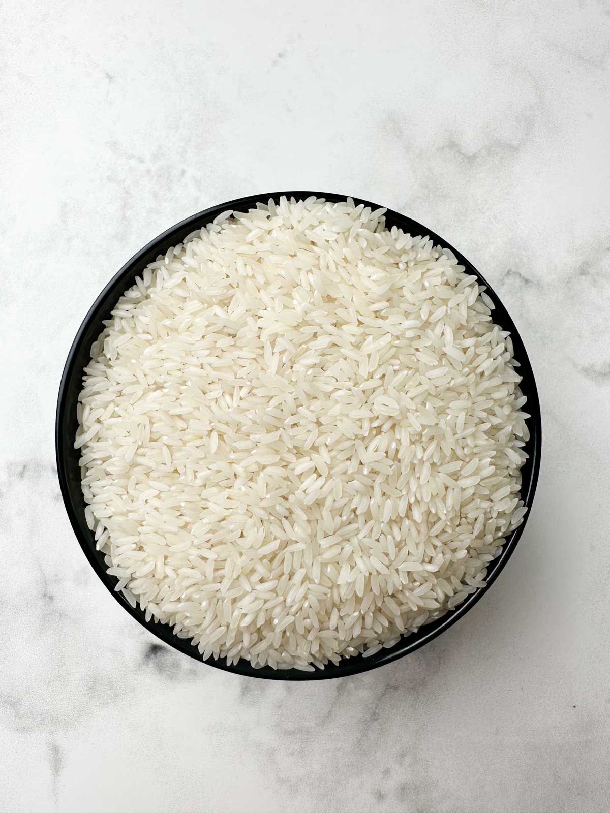 sona masoori rice in a black cup