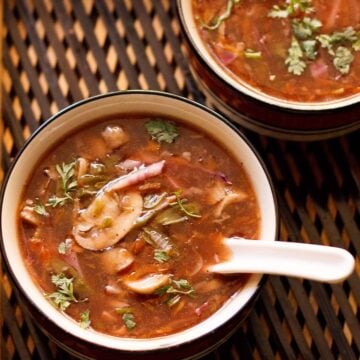 hot and sour soup served in two bowls with a spoon