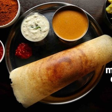 Masala dosa served on a plate with coconut chutney, sambar, red chutney, potato palya on the side.