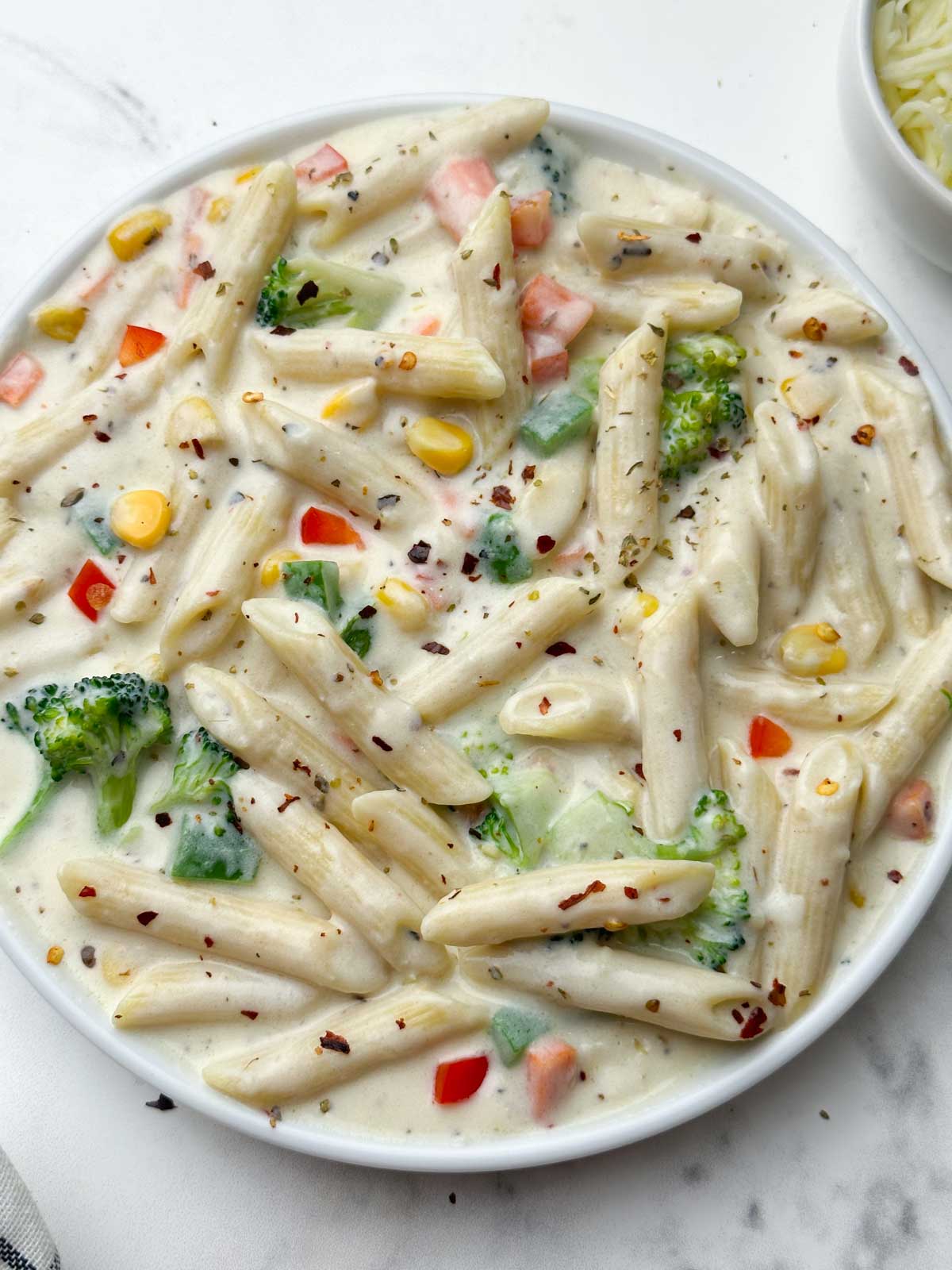 white sauce penne pasta served in a plate