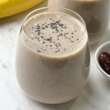 banana date smoothie served in 2 glasses topped with chia seeds