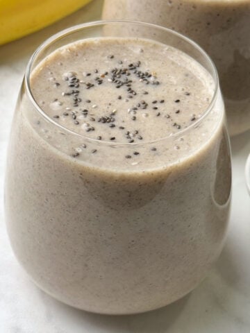 banana date smoothie served in 2 glasses topped with chia seeds