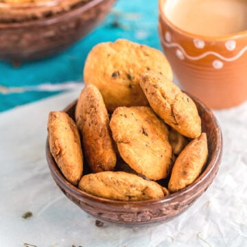 Methi Mathri served in a bowl with chai on the side