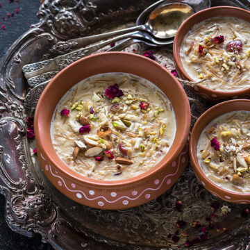 Sheer Khurma served in clay bowls with spoons on the side