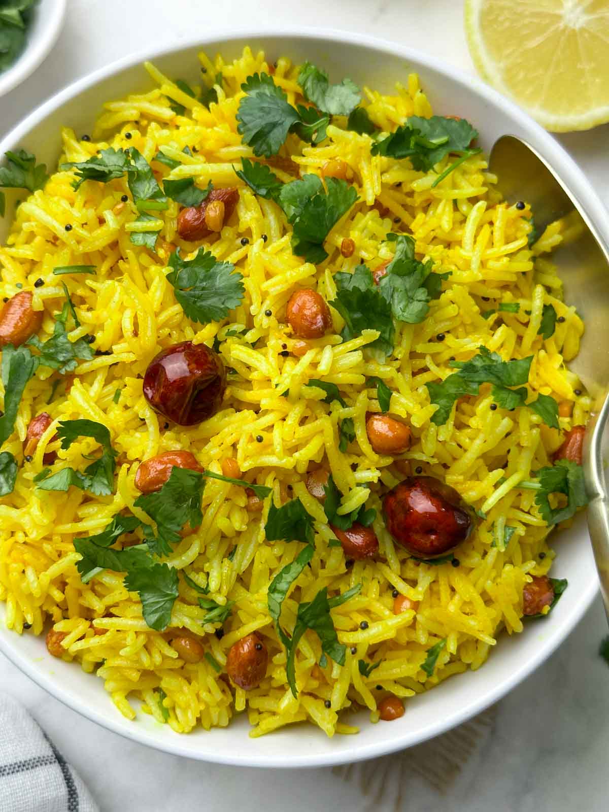 indian lemon rice served in a bowl with a spoon