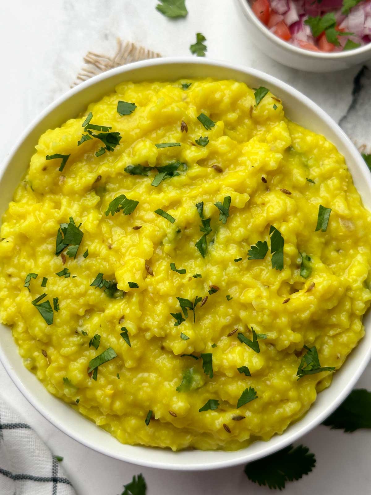 khichdi served in a bowl garnished with cilantro