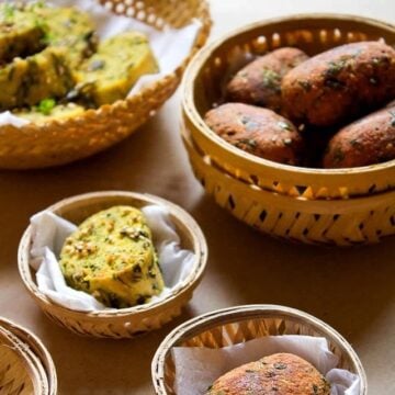 steamed and fried methi muthia served in baskets.