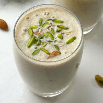 dried fruits milkshake served in a glass garnished with pistachios