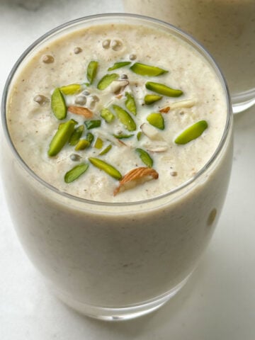 dried fruits milkshake served in a glass garnished with pistachios
