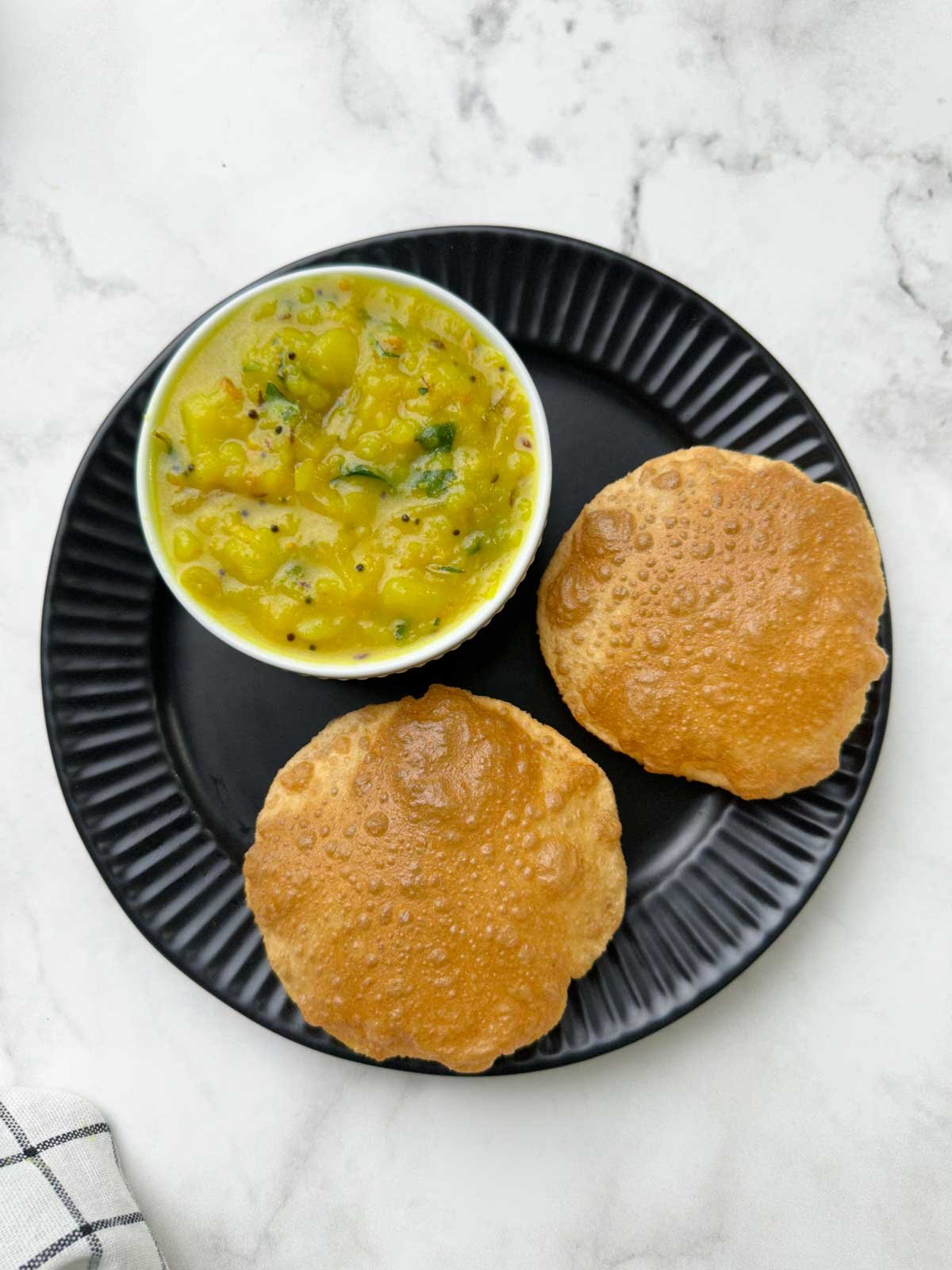 two poori and sagu on a plate