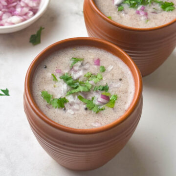 ragi ambli (ragi ganji) served in bowls with coriander and onion on the side