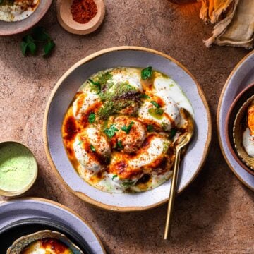 Dahi Bhalla served in a bowl with spoon