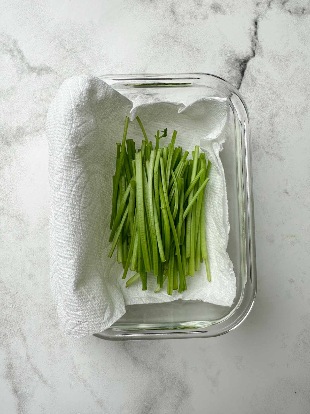 cilantro stalks in a glass container