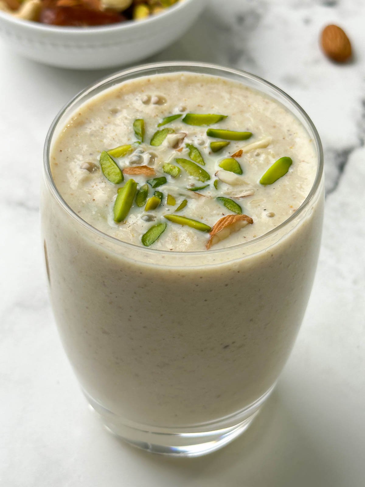 dried fruits milkshake served in a glass garnished with pistachios