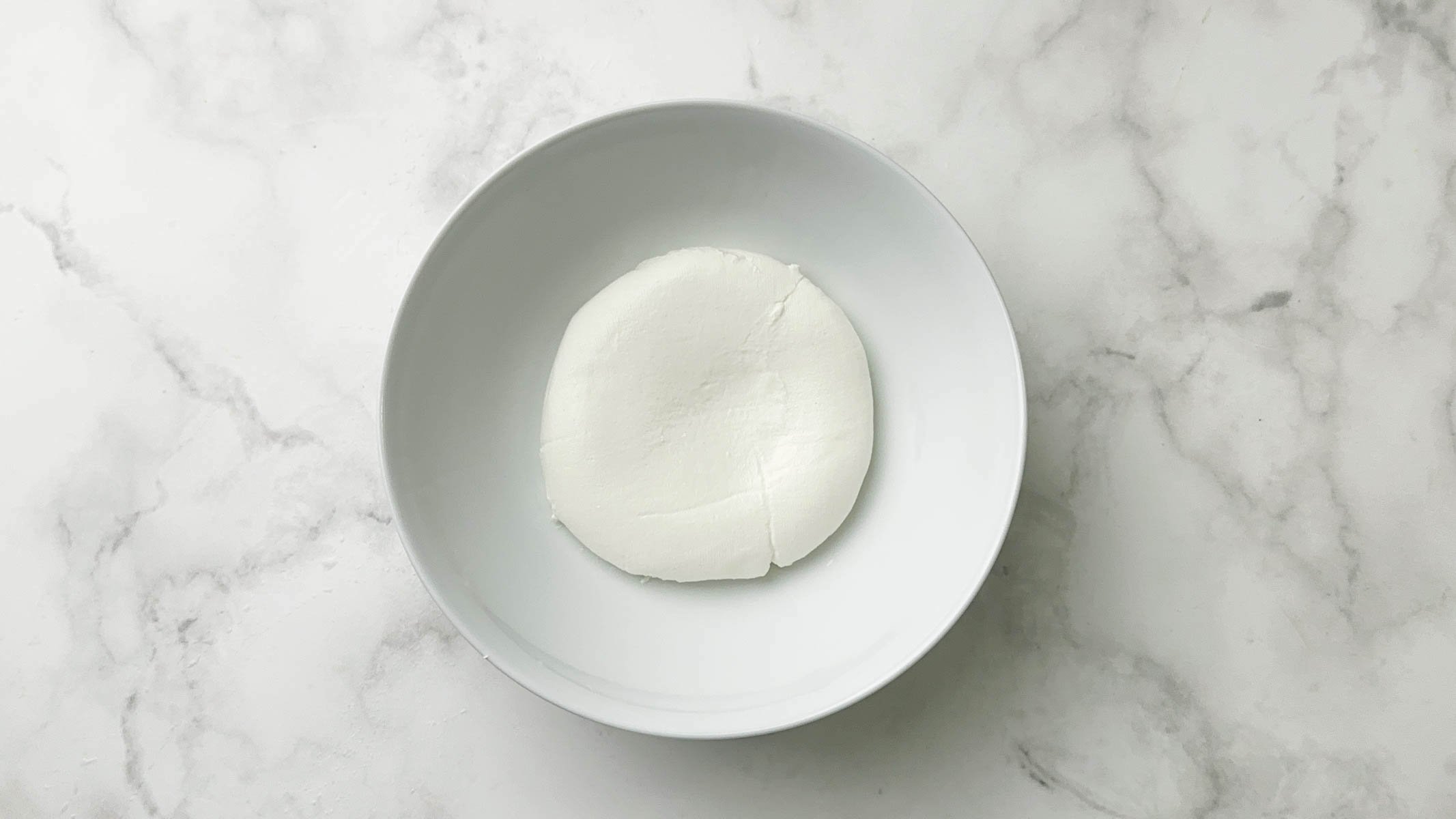 hung curd in a white bowl