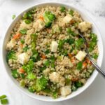 millet fried rice served in a bowl with a spoon