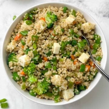 millet fried rice served in a bowl with a spoon