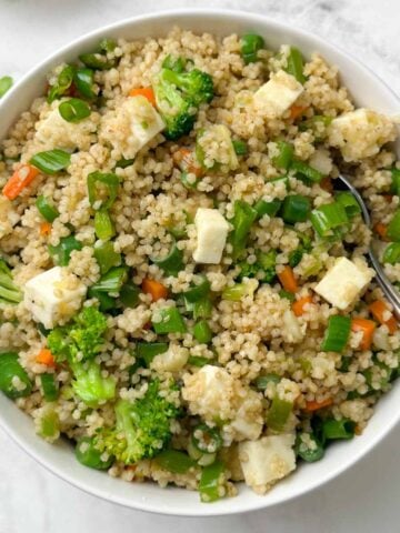 millet fried rice served in a bowl with a spoon