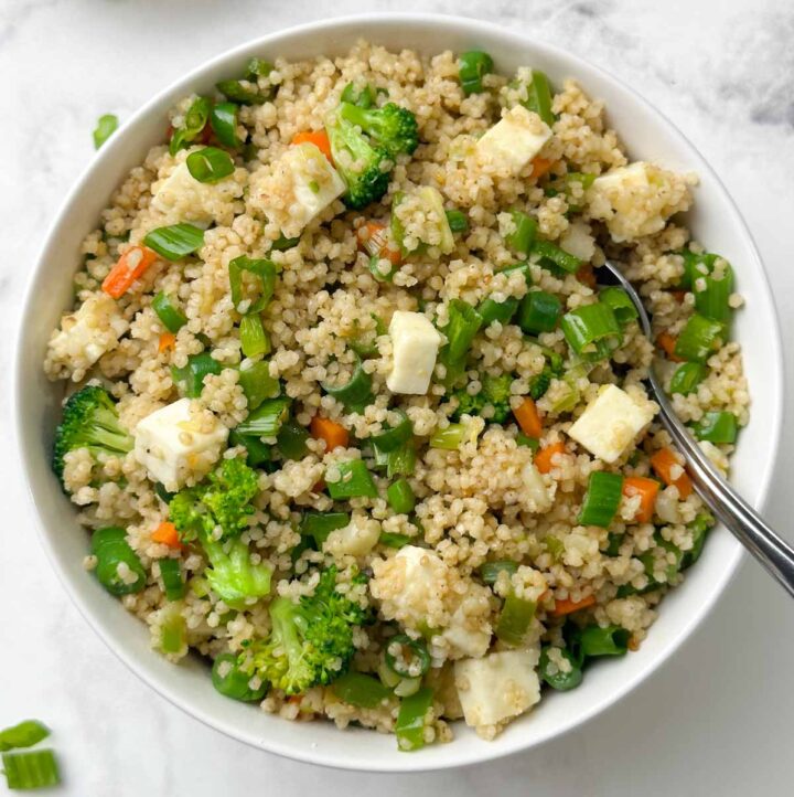 millet fried rice served in a bowl with a spoon