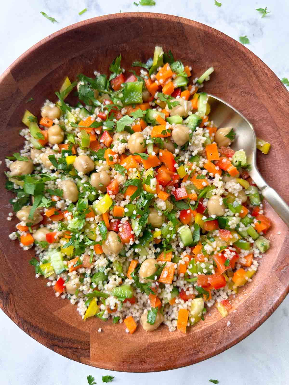 foxtail millet salad in a bowl with a spoon