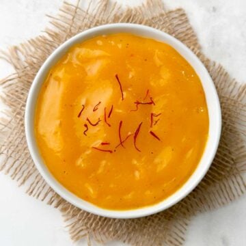 aamras served in a bowl garnished with saffron